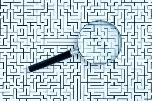Lupe auf einer Skizze eines Labyrinths. Link zur Übersicht der FFG-Förderungen